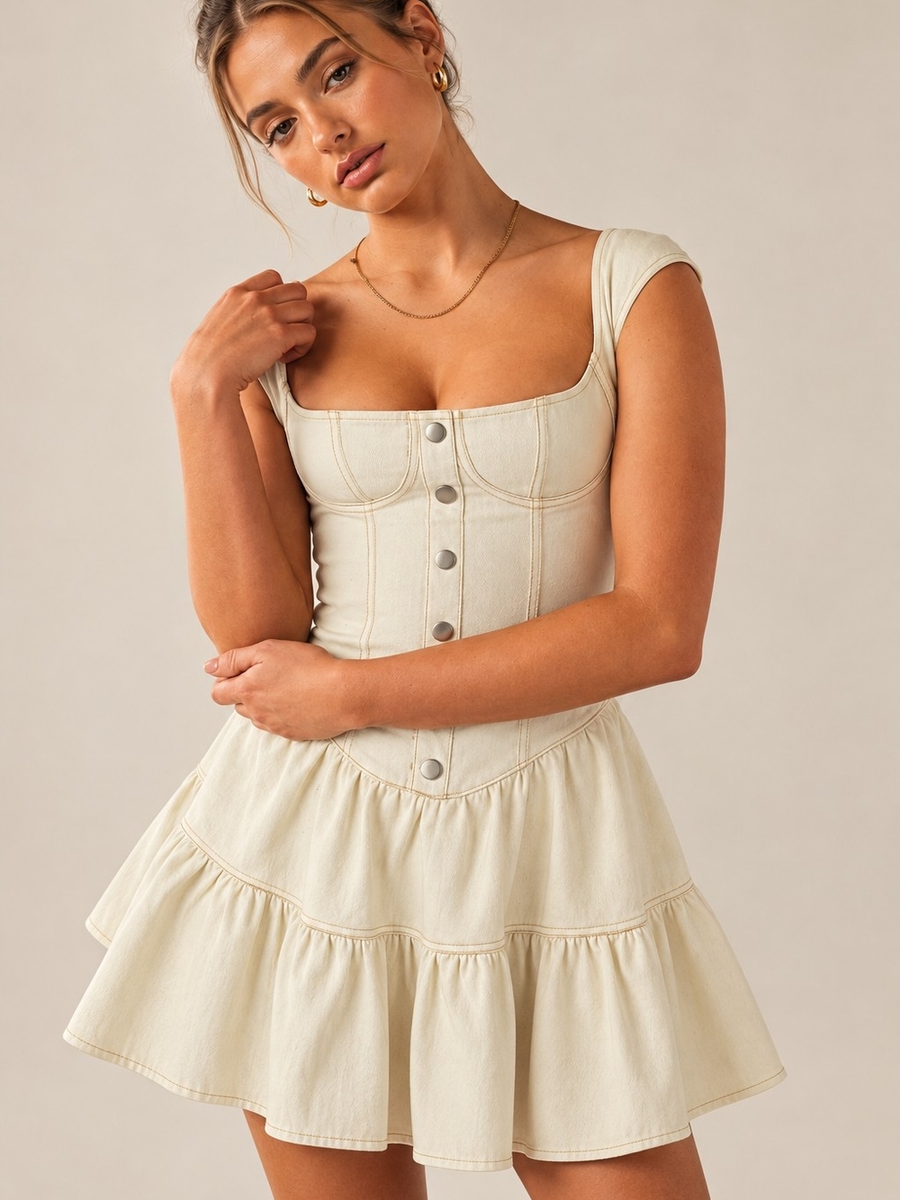 cream denim garment with contrast stitching and metal snap buttons By Peppermayo